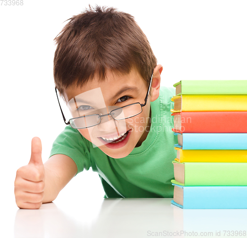 Image of Little boy is reading a book