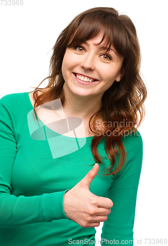 Image of Woman is showing thumb up gesture