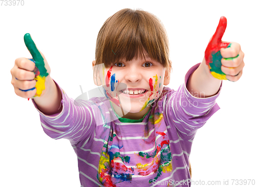 Image of Portrait of a cute girl playing with paints