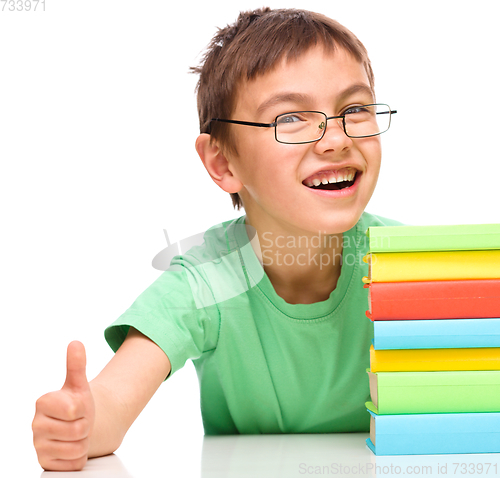 Image of Little boy is reading a book