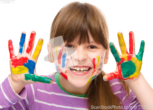 Image of Portrait of a cute girl playing with paints