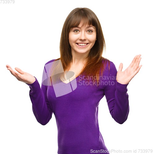 Image of Portrait of a young woman raised her hands up