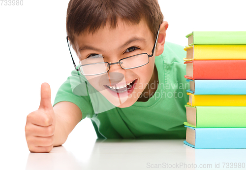 Image of Little boy is reading a book
