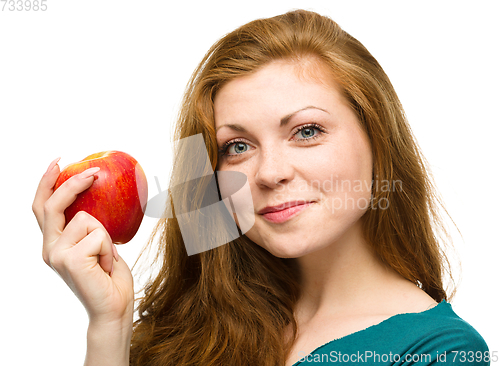 Image of Young happy girl with apple