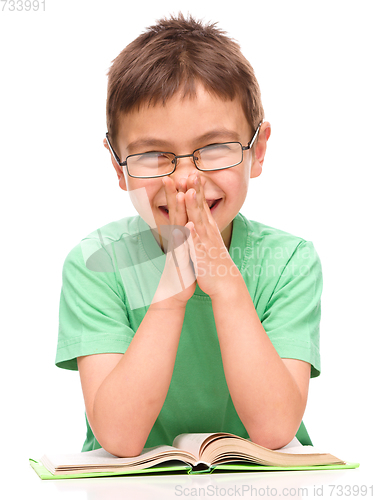 Image of Little boy is reading a book