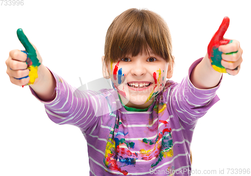 Image of Portrait of a cute girl playing with paints