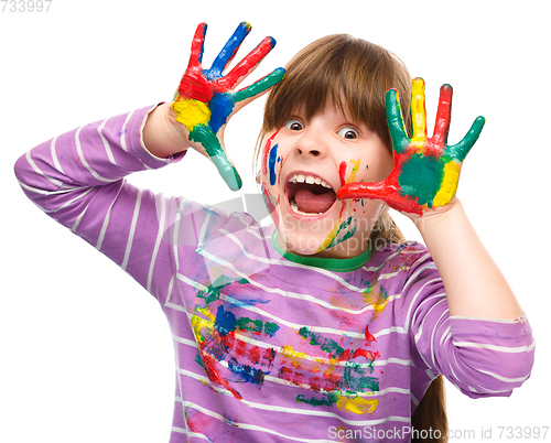 Image of Portrait of a cute girl playing with paints