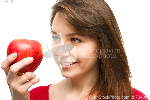 Image of Young happy girl with apple