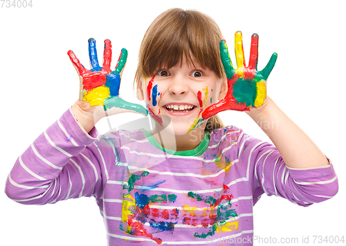 Image of Portrait of a cute girl playing with paints