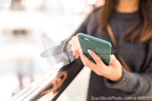 Image of Woman sending sms on mobile phone