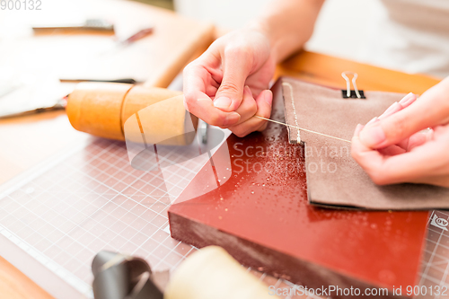 Image of Working process of the leather wallet in the leather workshop