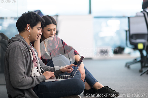 Image of software developers couple working on the floor