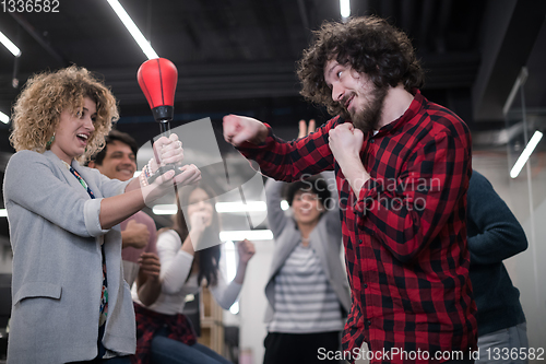 Image of multiethnics business team boxing at office