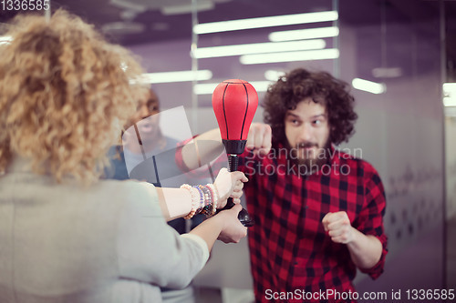 Image of multiethnics business team boxing at office