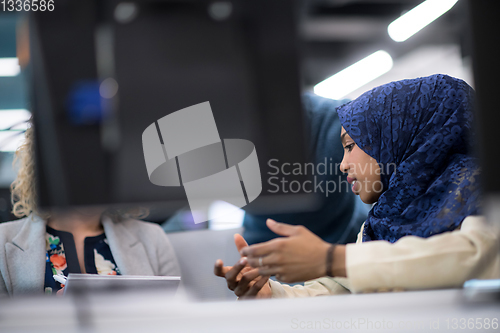 Image of black muslim female software developer at work