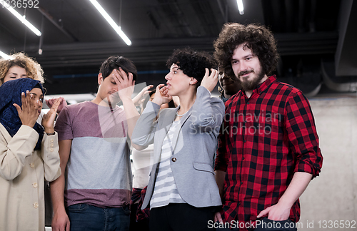 Image of portrait of young excited multiethnics business team