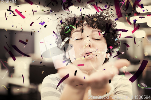Image of female software developer blowing confetti
