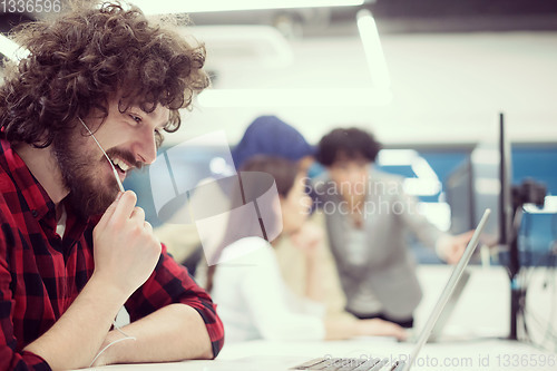 Image of young multiethnics team of software developers working together