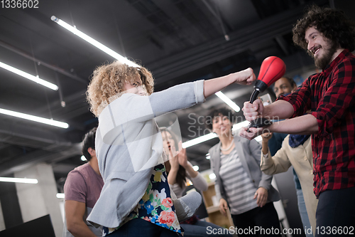 Image of multiethnics business team boxing at office