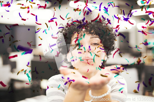 Image of female software developer blowing confetti