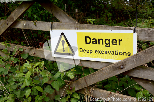 Image of Warning sign - Danger Deep Excavations - on a wooden gate