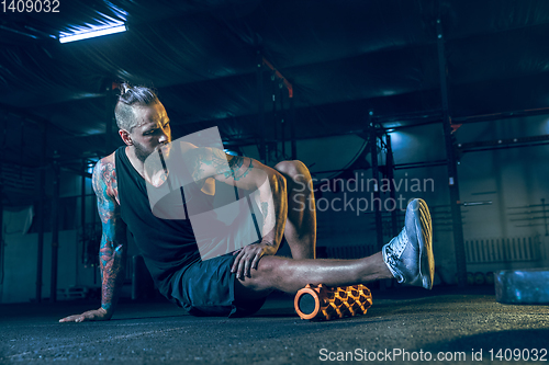 Image of Young healthy man athlete doing exercise in the gym