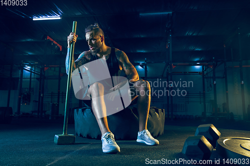 Image of Young healthy man athlete doing exercise in the gym