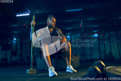 Image of Young healthy man athlete doing exercise in the gym