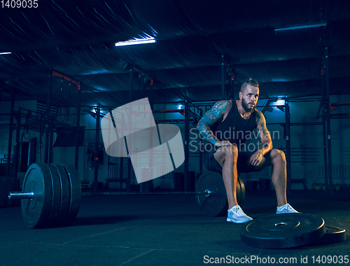 Image of Young healthy man athlete preparing for training in the gym