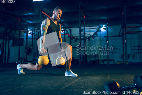 Image of Young healthy man athlete doing exercise in the gym