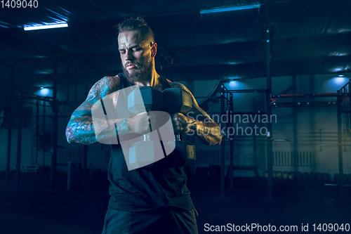 Image of Young healthy man athlete doing exercise in the gym