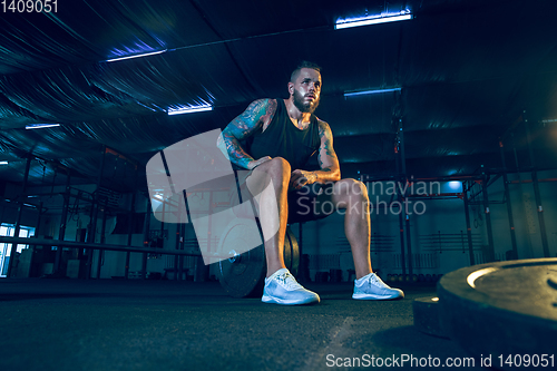 Image of Young healthy man athlete preparing for training in the gym