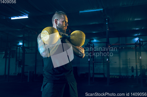 Image of Young healthy man athlete doing exercise in the gym