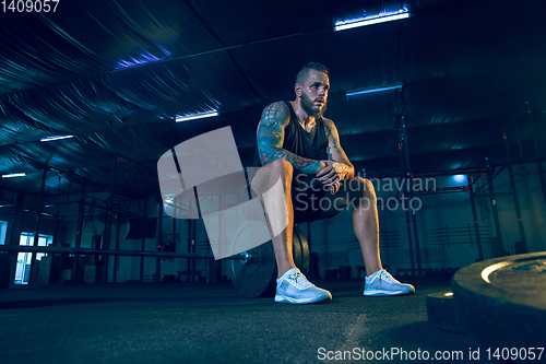 Image of Young healthy man athlete preparing for training in the gym