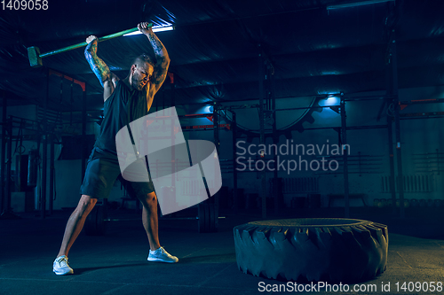 Image of Young healthy man athlete doing exercise in the gym