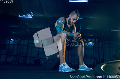 Image of Young healthy man athlete preparing for training in the gym