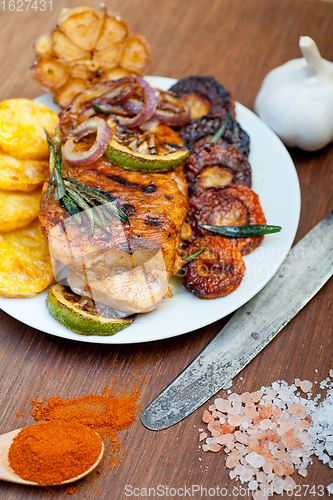Image of roasted grilled BBQ chicken breast with herbs and spices 