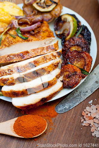 Image of roasted grilled BBQ chicken breast with herbs and spices 