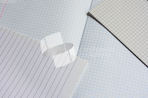 Image of Opened notebooks in a cage and a line close-up