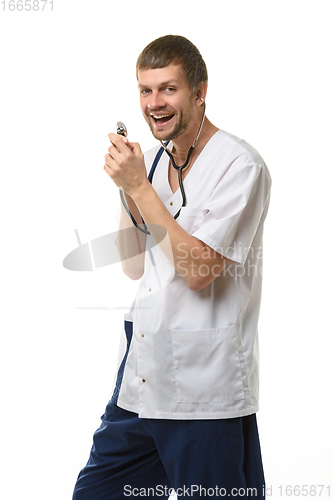 Image of Cheerful doctor singing into impromptu microphone from phonendoscope head isolated on white background