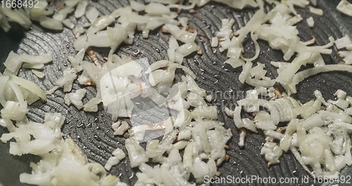 Image of Preparing onions in frying pen closeup footage