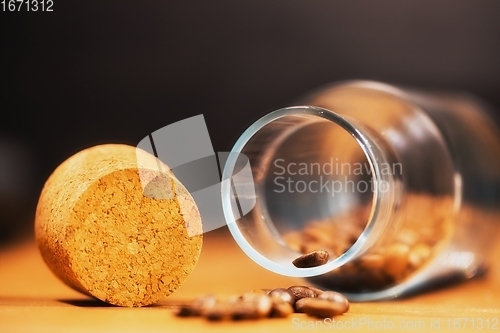 Image of Roasted coffee beans on table with jar