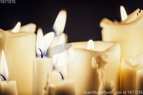 Image of Candles glowing against dark background