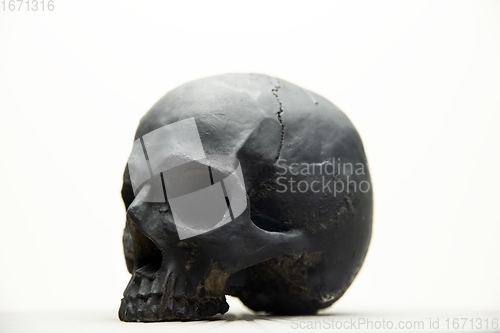 Image of Spooky dark black skull aginast white background isolated