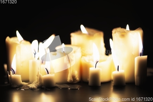 Image of Candles glowing against dark background