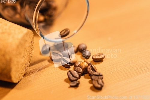 Image of Roasted coffee beans on table with jar