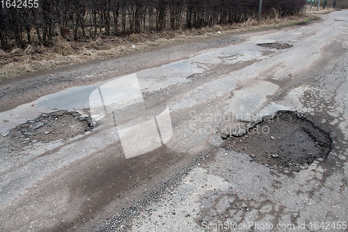 Image of Damaged asphalt road after winter.