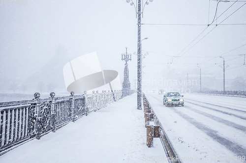 Image of Traffic on snow covered bridge during heavy snow storm