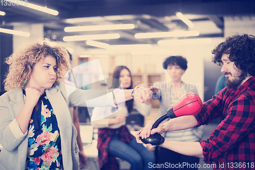 Image of multiethnics business team boxing at office