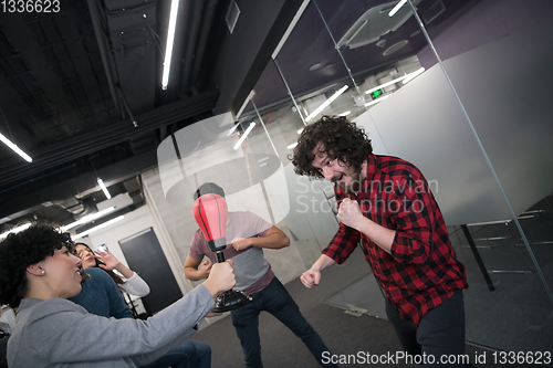 Image of multiethnics business team boxing at office